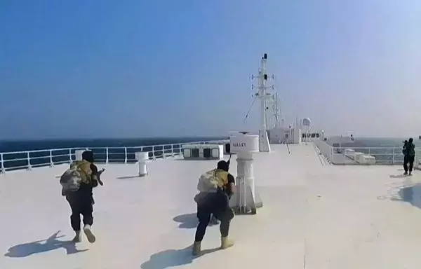 A screen grab from footage released by the Houthis' Ansarullah Media Centre on November 19 reportedly shows members of the militia during the capture of an Israel-linked cargo vessel at an undefined location in the Red Sea. [Ansarullah Media Center/AFP]