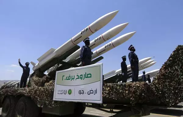 Houthi fighters stand on a missile carrier during a September 21 parade marking the ninth anniversary of the Iran-backed group's seizure of Sanaa. [Mohammed Huwais/AFP]