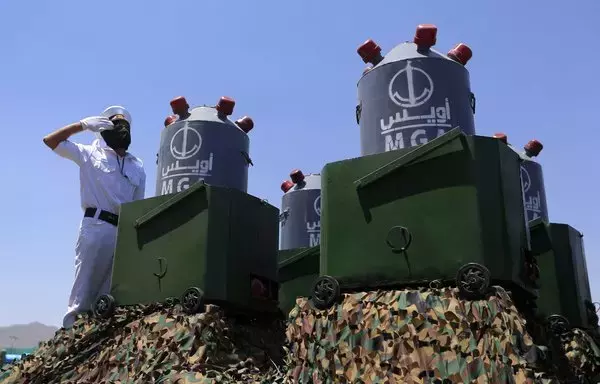 Naval mines are displayed on the back of a vehicle on September 21, during a military parade marking the ninth anniversary of the Houthis' takeover of Sanaa. [Mohammed Huwais/AFP]