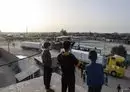 
Young boys look at trucks carrying humanitarian aid entering Gaza via the Rafah crossing with Egypt on November 26, the third day of a truce between Israel and Hamas. [Mohammed Abed/AFP]        