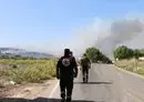 
Lebanese civil defense volunteers walk towards a forest fire that reportedly ignited after shelling from Israel in Alma al-Shaab, close to south Lebanon's border with Israel on October 26, amid the ongoing battles between Israel and Hamas in the Gaza strip. [AFP]        