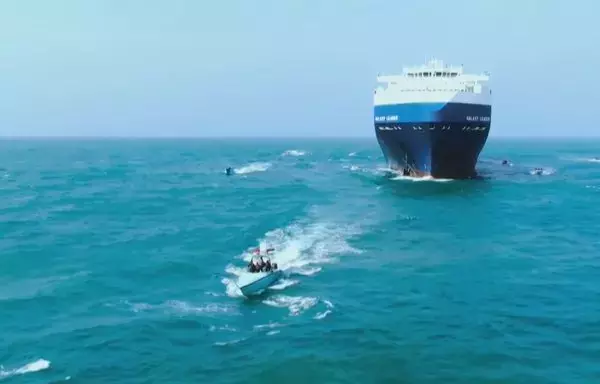 A screen grab from propaganda footage released by the Houthis November 19 reportedly shows the group during the capture of an Israel-linked cargo vessel at an undefined location in the Red Sea. [Ansarullah Media Centre/AFP]