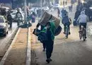 
Palestinians carry some belongings as they move to safer areas following the resumption of Israeli strikes on Rafah in the southern Gaza strip on December 1, after the expiration of a seven-day truce between Israel and Hamas. [Mahmud Hams/AFP]        