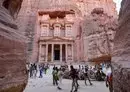 
Visitors tour near the Treasury at the ruins of the ancient Nabatean city of Petra in southern Jordan on December 12, 2022. Petra drew 900,000 visitors last year, close to the previous record of one million set in 2019. Now, the Israel-Hamas war threatens to undo those gains. [Khalil Mazraawi/AFP]        