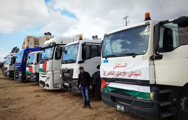 An aid convoy transporting a Jordanian field hospital is seen parked upon arrival in Khan Yunis in the southern Gaza strip on November 20, after passing through the Rafah border crossing with Egypt amid continuing battles between Israel and Hamas. [Mahmud Hams/AFP]