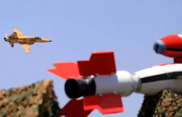 A fighter jet flies over during a Houthi military parade marking the ninth anniversary of the Iran-backed group's coup on September 21. [Mohammed Juwais/AFP]