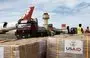 
Workers unload humanitarian aid at Egypt's al-Arish Airport on November 22, ahead of being transported to the Rafah border crossing with Gaza. [Khaled Desouki/AFP]        