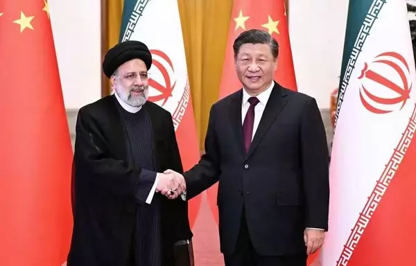 Iranian president Ebrahim Raisi shakes hands with Chinese President Xi Jinping in February. [IRNA]