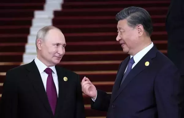 Russia's President Vladimir Putin and Chinese President Xi Jinping interact on October 17 in Beijing. [Sergei SAVOSTYANOV / POOL / AFP]