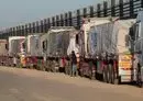 
Trucks with humanitarian aid wait on th Egyptian side of the Rafah crossing with Gaza on December 11. Israel on December 12 announced an additional checkpoint for examining relief supplies before dispatching them to Gaza via the Rafah crossing. [Giuseppe Cacace/AFP]        