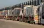 
Trucks with humanitarian aid wait on th Egyptian side of the Rafah crossing with Gaza on December 11. Israel on December 12 announced an additional checkpoint for examining relief supplies before dispatching them to Gaza via the Rafah crossing. [Giuseppe Cacace/AFP]        