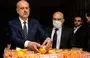 
Lebanon's Interior Minister Bassam al-Mawlawi (left) checks one of the fake oranges filled with Captagon pills and concealed in boxes containing real fruit, after the shipment was intercepted by the customs and the anti-drug brigade at the Beirut port on December 29, 2021. [Anwar Amro/AFP]        