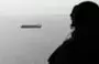 
A picture taken on August 10, 2018, shows an Emirati soldier watching from a military plane a ship crossing Bab al-Mandeb strait at the southern entrance to the Red Sea. [Karim Sahib/AFP]        