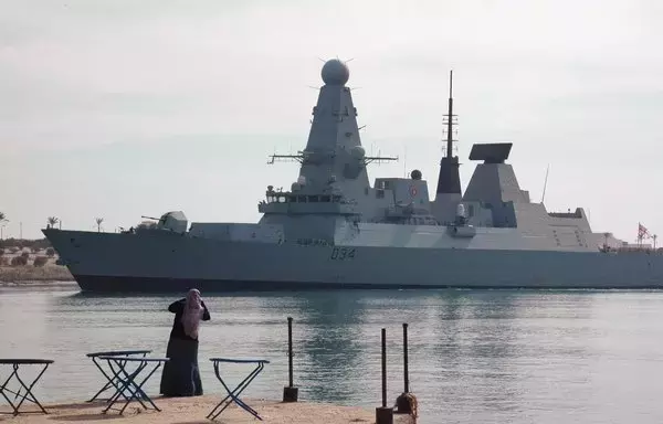 An Egyptian watches the British destroyer HMS Diamond sail through the Suez Canal on December 2, 2012. The destroyer brought down a suspected attack drone targeting merchant shipping in the Red Sea, British Defence Secretary Grant Shapps said December 16, 2023. [STR/AFP]