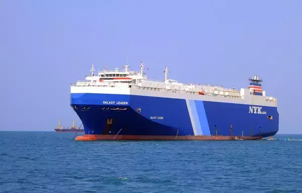 A picture taken during a tour organized by the Iran-backed Houthis on November 22 shows the Galaxy Leader cargo ship, seized by Houthi fighters two days earlier, in the Red Sea off Yemen's al-Hodeidah province. The 25-member international crew of the Bahamas-flagged, British-owned vessel, operated by a Japanese firm, were taken hostage by the Houthis on November 19 and are still detained in Yemen. [AFP]