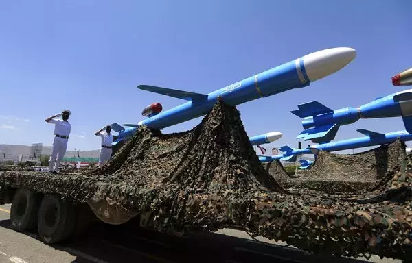 Houthis stand on a missile carrier during a military parade in Sanaa on September 21. [Mohammed Huwais/AFP]