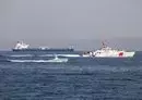 
US Coast Guard Cutter John Scheuerman transits the Strait of Hormuz with an L3 Harris Arabian Fox MAST-13 unmanned surface vessel on April 19. [US Navy]        