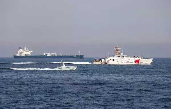 US Coast Guard Cutter John Scheuerman transits the Strait of Hormuz with an L3 Harris Arabian Fox MAST-13 unmanned surface vessel on April 19. [US Navy]