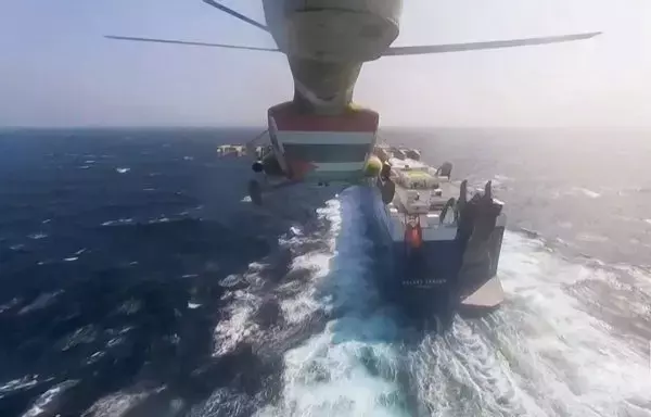 A screenshot from footage released by the Houthis on November 19 reportedly shows Houthi attackers during the capture of Israel-linked cargo vessel Galaxy Leader at an undefined location in the Red Sea. [Ansarullah Media Center/AFP]