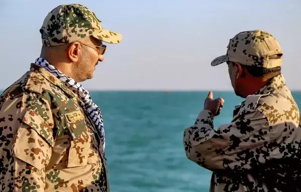 Brig. Gen. Tariq Muhammad Abdullah Saleh of the Presidential Command Council in Yemen's internationally recognized government, observes as Coast Guard members patrol in the Red Sea off the coast of Mokha in Taez province on December 12. [Khaled Ziad/AFP]