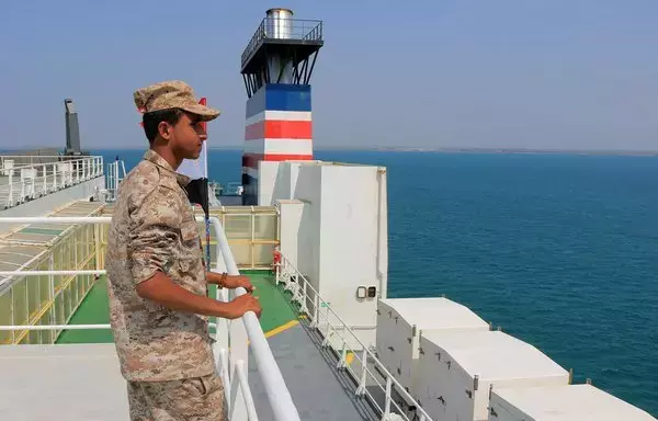 A security guard aboard the Galaxy Leader cargo ship, which was seized by Houthi fighters on November 19, in a port on the Red Sea in the Yemeni province of al-Hodeidah. [AFP]