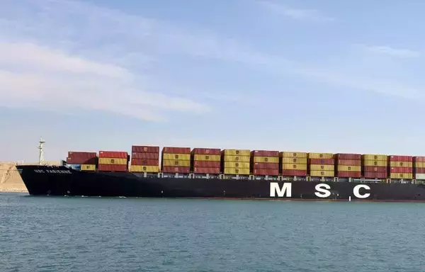 A container ship transits the Suez Canal off Port Said in this photo, posted to the Suez Canal Authority Facebook page on December 17.