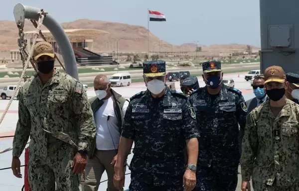 USS Monterey commanding officer Capt. Joseph Baggett, Egyptian Naval Force commander Vice Adm. Ahmed Khaled Hassan Saeed, and Vice Adm. Brad Cooper, commander of US Naval Forces Central Command, the US Navy's 5th Fleet and the multinational Combined Maritime Forces, walk together during a tour of the guided-missile cruiser in Berenice, Egypt, on August 12, 2021. [US Navy]