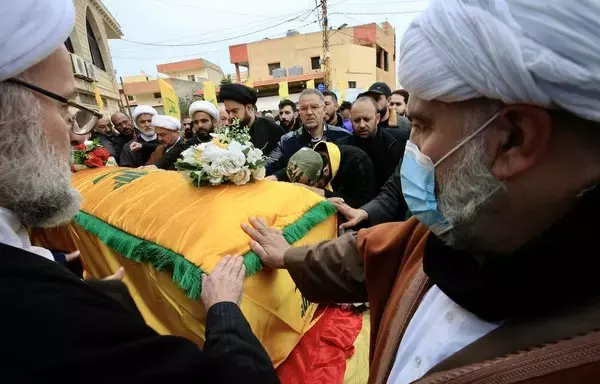 Mourners pray over the coffin of a Hizbullah member who was killed December 20 in southern Lebanon in cross-border fire with Israeli troops, during his funeral in Markaba on December 21. [AFP]