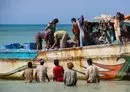 
Yemeni fishermen unload their catch from a boat on the Red Sea coast in the Khokha district of the war-ravaged country's western province of al-Hodeidah on December 27. [Khaled Ziad/AFP]        