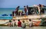 
Yemeni fishermen unload their catch from a boat on the Red Sea coast in the Khokha district of the war-ravaged country's western province of al-Hodeidah on December 27. [Khaled Ziad/AFP]        