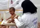 
A UN nurse tends to a malnourished child at a treatment center in Yemen's western province of al-Hodeidah on February 15, 2022. [Photo by Khaled Ziad/AFP]        