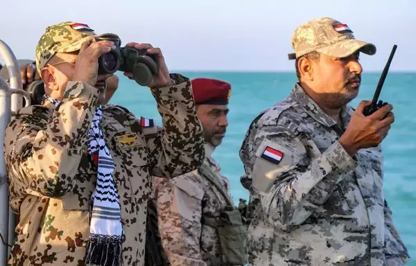 Brig. Gen. Tariq Muhammad Abdullah Saleh, member of the Presidential Command Council in Yemen's internationally recognized government, looks through binoculars as he observes coastguard members patrolling in the Red Sea off the town of Mokha in Taez province, near the strategic Bab al-Mandeb strait, on December 12. [Khaled Ziad/AFP]