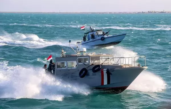 Yemeni coastguard members loyal to the internationally recognized government ride in a speedboat and a patrol boat cruising in the Red Sea off Mokha in Taez province, near the strategic Bab al-Mandeb strait, on December 12. [Khaled Ziad/AFP]