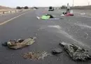 
Bodies lie on a main road near the Gevim Kibbutz, close to the border with Gaza, on October 7, following Hamas's terror attack on Israel. [Oren Ziv/AFP]        