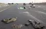 
Bodies lie on a main road near the Gevim Kibbutz, close to the border with Gaza, on October 7, following Hamas's terror attack on Israel. [Oren Ziv/AFP]        