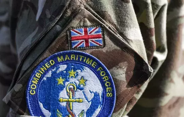 This picture taken in 2019, during the International Maritime Exercise in the Gulf waters off Bahrain, shows a badge of the Combined Maritime Forces (CMF) on the uniform of a British serviceman. [Karin Sahib/AFP]