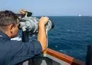 
In support of Operation Prosperity Guardian, a sailor aboard guided-missile destroyer USS Mason uses high-powered binoculars to keep an eye on shipping in the Red Sea. [CMF]        