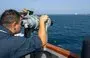 
In support of Operation Prosperity Guardian, a sailor aboard guided-missile destroyer USS Mason uses high-powered binoculars to keep an eye on shipping in the Red Sea. [CMF]        