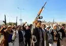 
Houthi fighters brandish their weapons in Sanaa on January 11. [Mohammed Huwais/AFP]        