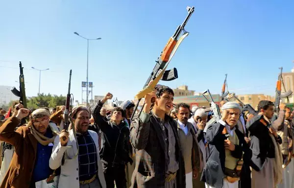 Houthi fighters brandish their weapons in Sanaa on January 11. [Mohammed Huwais/AFP]