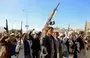 
Houthi fighters brandish their weapons in Sanaa on January 11. [Mohammed Huwais/AFP]        