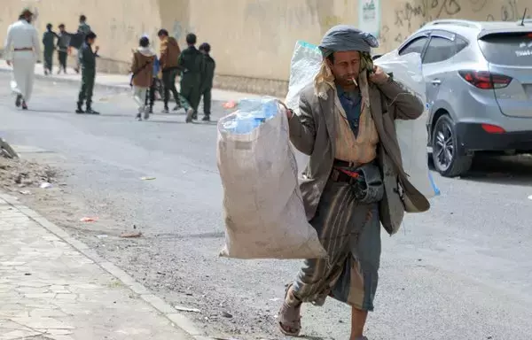 A Yemeni man collects plastic waste from the streets in the capital Sanaa on March 19, 2022. [Mohammed Huwais/AFP]