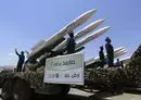 
Houthi fighters stand guard on a missile carrier during a military parade in Sanaa on September 21, 2023. [Mohammed Huwais/AFP]        