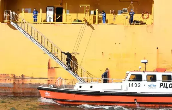 A Suez Canal escort boat communicates with a ship crossing the canal on January 13. [Suez Canal Authority]