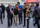 
People injured in twin bombings that struck a crowd marking the anniversary of the 2020 killing of IRGC commander Qassem Soleimani are helped outside a hospital in the southern Iranian city of Kerman on January 3. [Sare Tajalli/ISNA/AFP]        