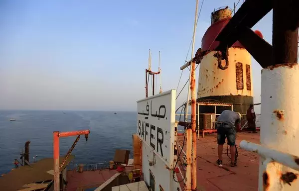 A worker stands on the deck of the beleaguered Yemen-flagged FSO Safer oil tanker in the Red Sea off the coast of Yemen's al-Hodeidah on July 15, 2023. [Mohammed Huwais/AFP]