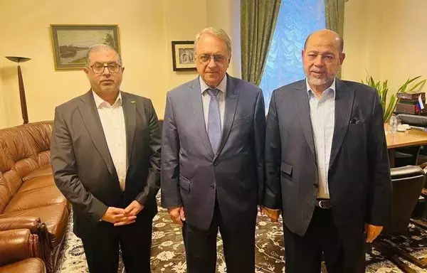 Russian Deputy Foreign Minister Mikhail Bogdanov (center) hosts a meeting with Hamas representative Moussa Abu Marzouk (right) in Moscow on October 26. [File]