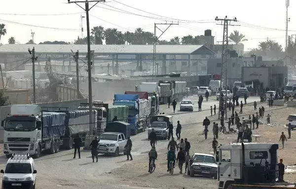 Trucks carrying humanitarian aid enter Rafah in the southern Gaza strip after crossing the terminal border from Egypt, on January 17. [AFP]