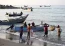 
Fishermen unload their catch from a boat in al-Khokha district of Yemen's al-Hodeidah province on January 16. The Houthis have reportedly recruited fishermen to smuggle arms into the country. [Khaled Ziad/AFP]        