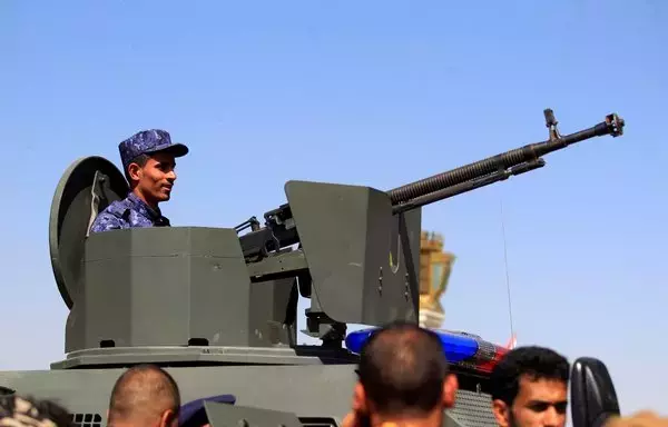 A fighter loyal to Yemen's Houthis mans a turret in an armored vehicle outside Al-Saleh grand mosque in Sanaa on October 12, 2022. [Mohammed Huwais/AFP]